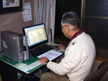 パソコンの操作で頑張る高齢者